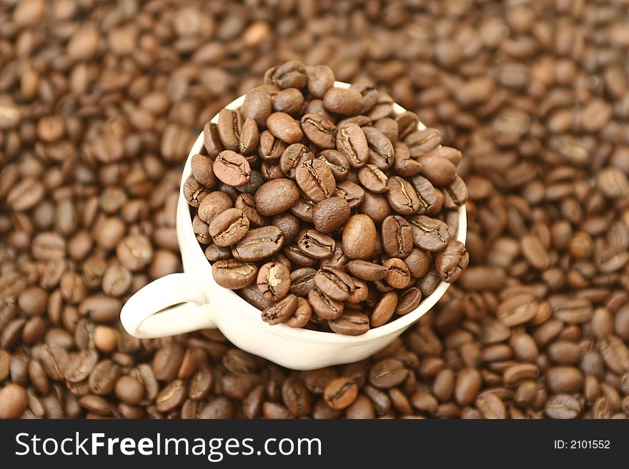 Full cup with grains of coffee. Full cup with grains of coffee
