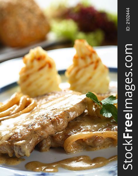 Beef chops with dressing decorated green parsley