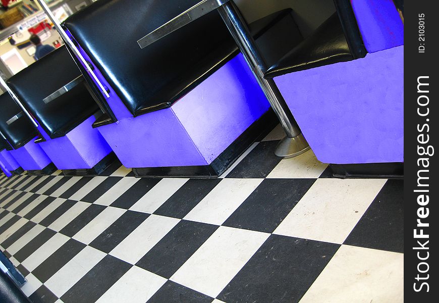 Vintage restaurant with checkerboard floor and blue booths