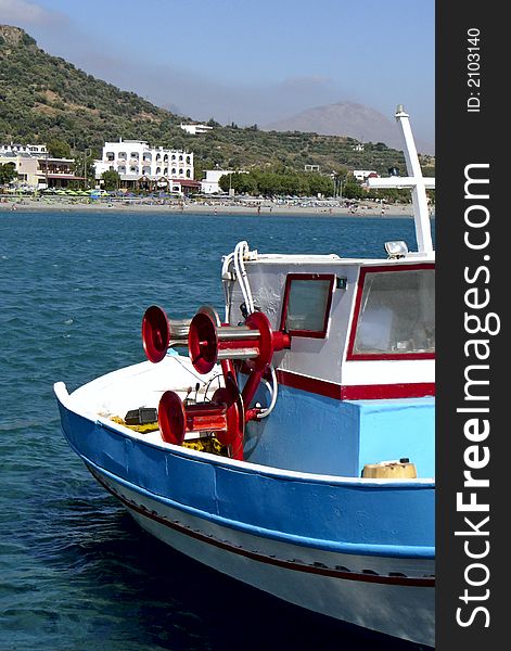 Crete colorful fishing boat with view on island. Crete colorful fishing boat with view on island