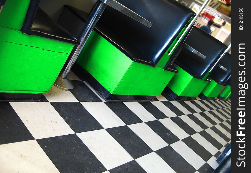 Vintage restaurant with checkerboard floor and green booths