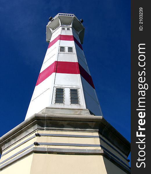 Closeup portrait of lighthouse in blue sky. Closeup portrait of lighthouse in blue sky