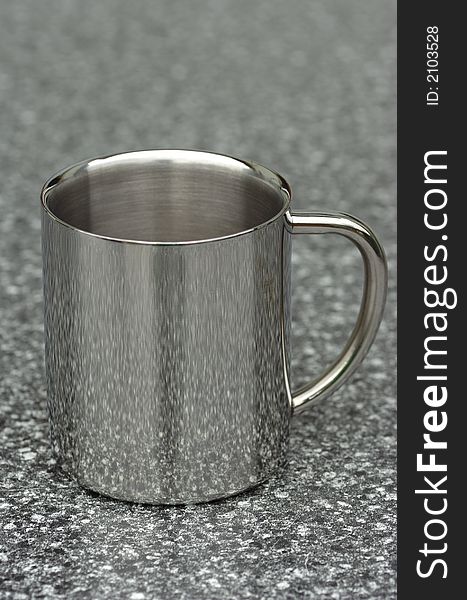 Steel coffee cup on a grey table