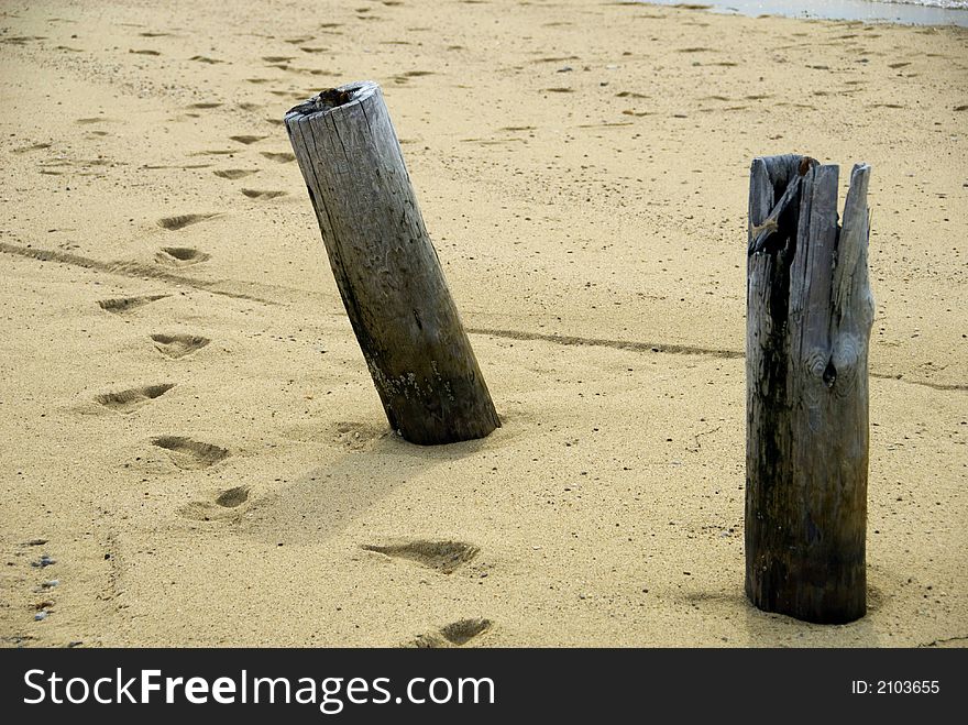 A pair of posts on a deserted beach. A pair of posts on a deserted beach