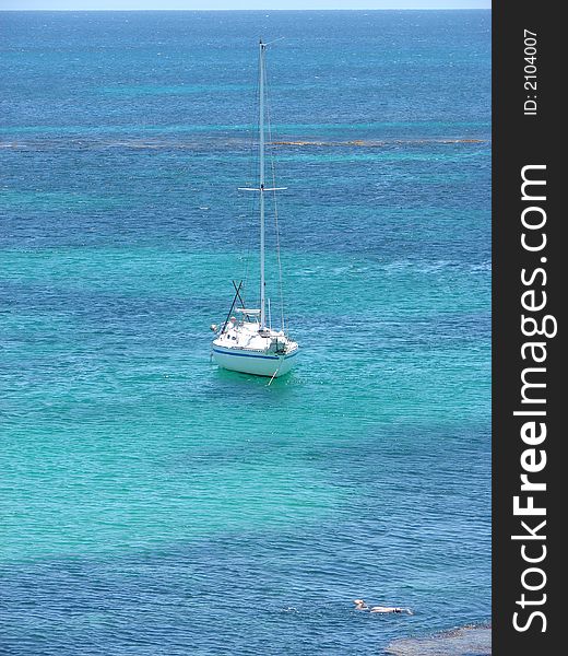 A yacht moored in beautiful clear blue water. A yacht moored in beautiful clear blue water