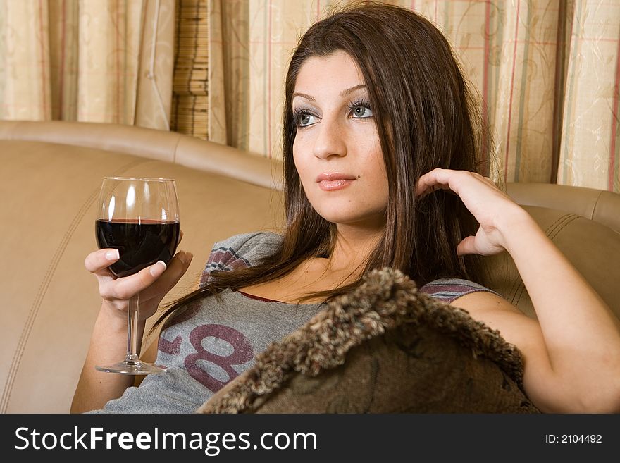 A women sitting on the couch thinkig. A women sitting on the couch thinkig
