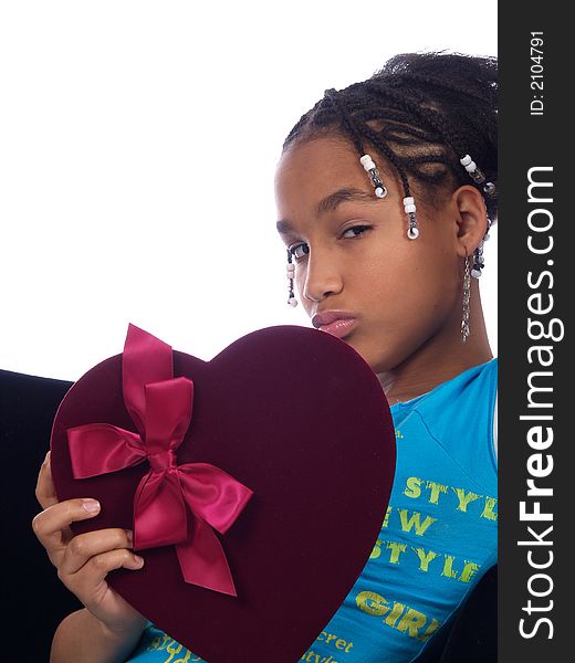 A cute young girl with a heartache holding a heart