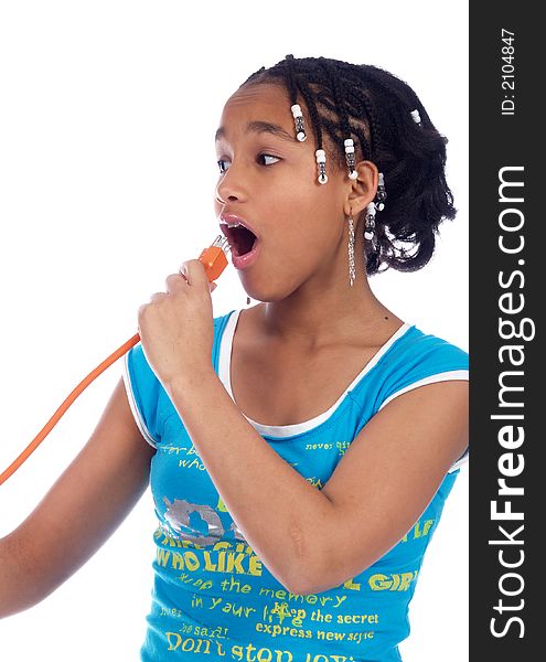 Young girl putting powercable in her mouth. Young girl putting powercable in her mouth