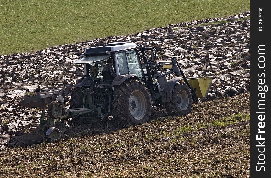 Tractor plowing a field at spring time. Tractor plowing a field at spring time