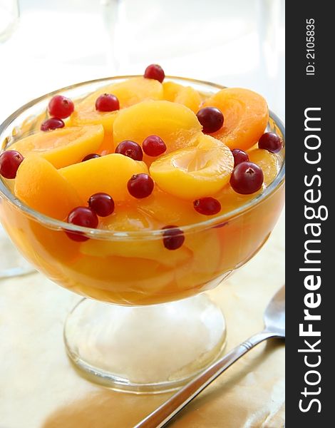 Juicy apricots with cranberries. Light background. Juicy apricots with cranberries. Light background.