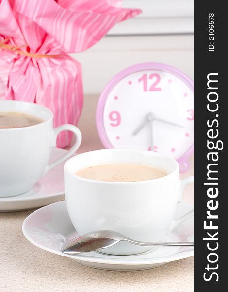 Cups of coffee and a clock in the background. Cups of coffee and a clock in the background.