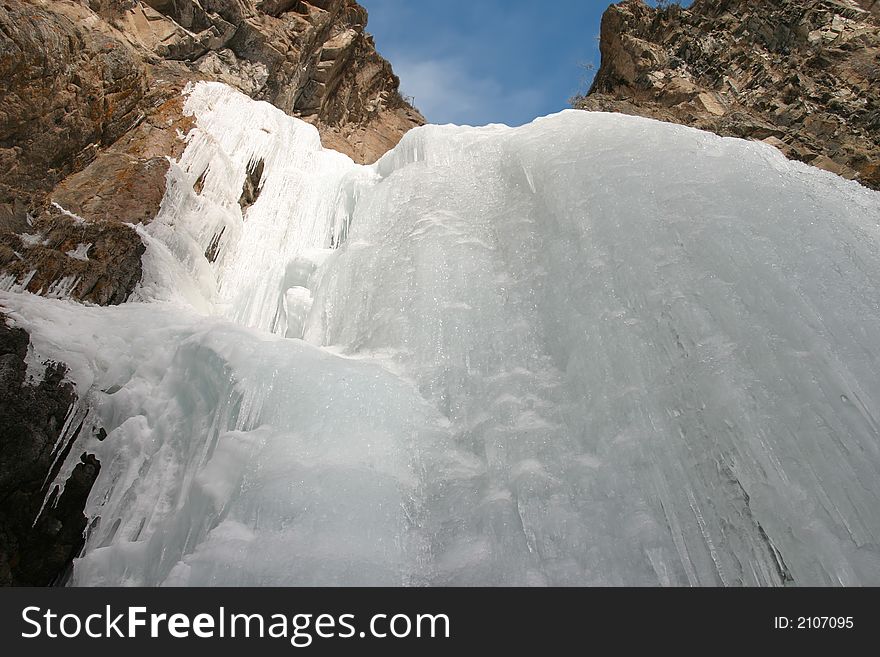 Frozen waterfall brights on sun incident rays. Frozen waterfall brights on sun incident rays