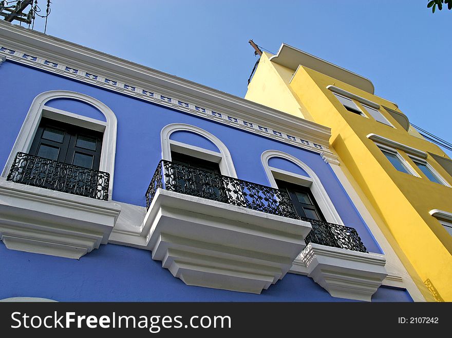 Blue and yellow buildings in a tropical city