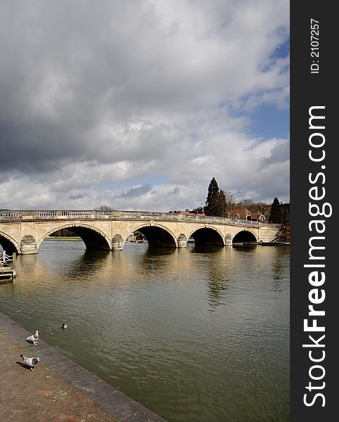 Storm Clouds over an Historic Road Bridge over the River Thames in England. Storm Clouds over an Historic Road Bridge over the River Thames in England