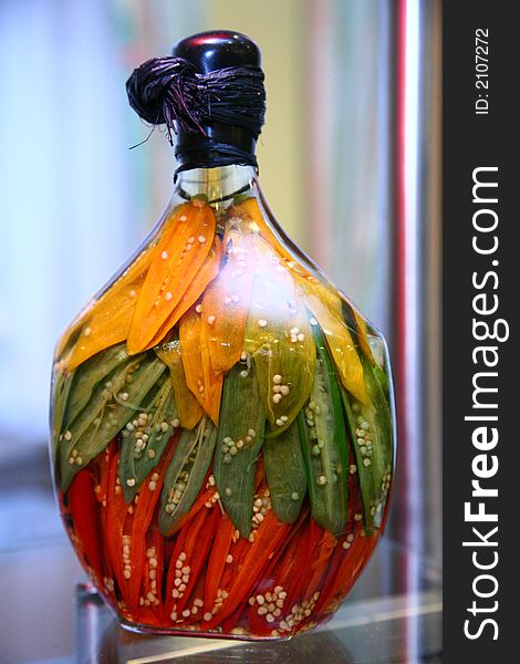 Bottle containing fruits,herbs and parts of them. Fruits are placed into the bottle with high skill and feeling for colors. Alcohol is used for conservation. Bottle containing fruits,herbs and parts of them. Fruits are placed into the bottle with high skill and feeling for colors. Alcohol is used for conservation