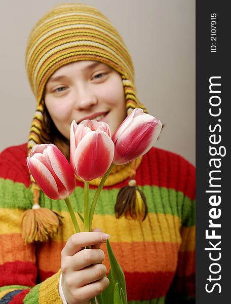 Girl in striped cap with three tulips. Girl in striped cap with three tulips.