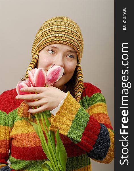 Romantic girl in yellow cap with tulips. Romantic girl in yellow cap with tulips