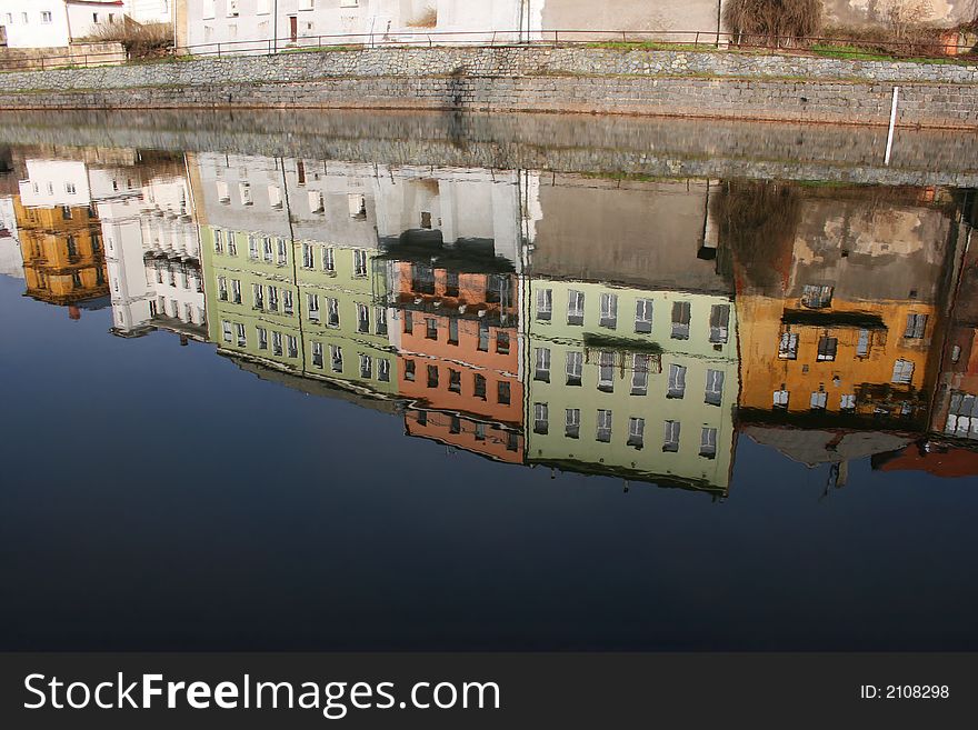Reflection of houses in surface of river. Reflection of houses in surface of river