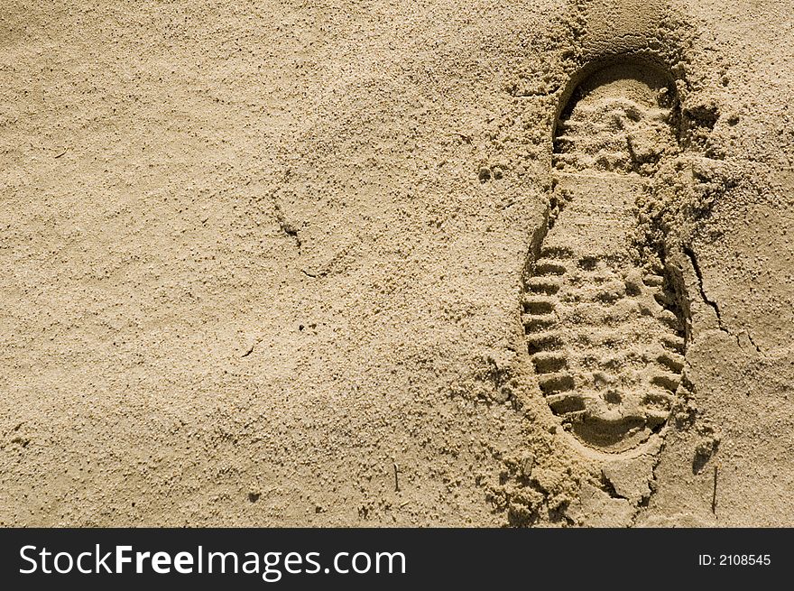 Single footprint impression in the desert sand on right of image. Single footprint impression in the desert sand on right of image