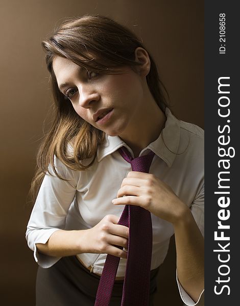 Women at work: irritated businesswoman fixing her tie. Women at work: irritated businesswoman fixing her tie