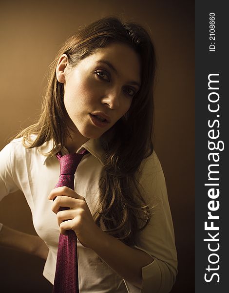 Women at work: irritated businesswoman fixing her tie. Women at work: irritated businesswoman fixing her tie