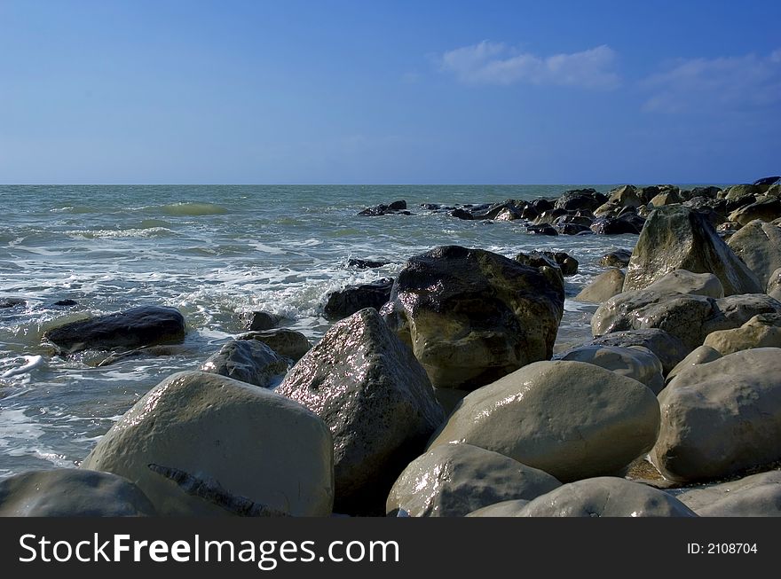 Rugged seashore rocks and horizon with dark blue skies. Rugged seashore rocks and horizon with dark blue skies