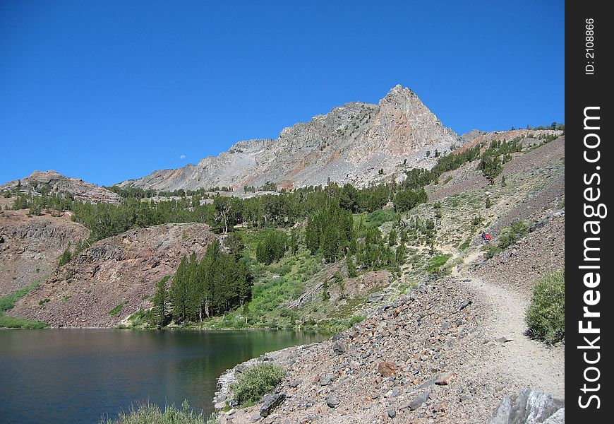 Blue lake with an anonymous peak behind. The location is the eastern sierras