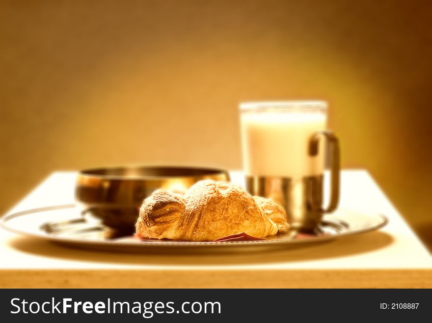 Sepia picture of a healthy breakfast (focus on croissante)
