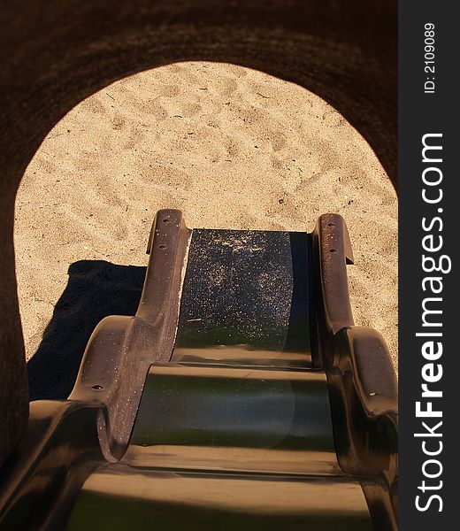 View of a slide through hood into a sandbox. View of a slide through hood into a sandbox.