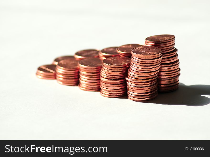 Stacks of pennies against a white background. Stacks of pennies against a white background