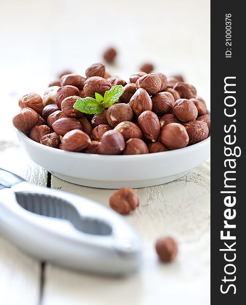 Hazelnuts in bowl with nutcracker