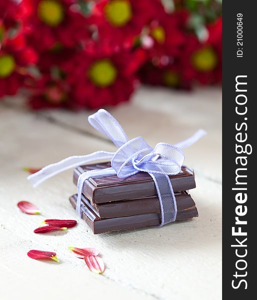 Chocolate with ribbon and petals