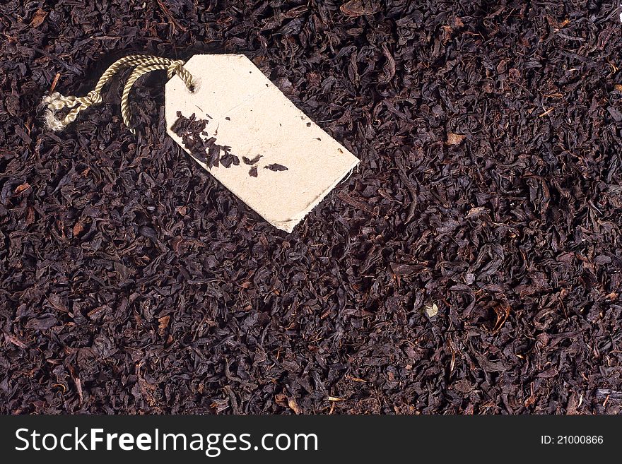 Macro photo of black tea leaves and paper label