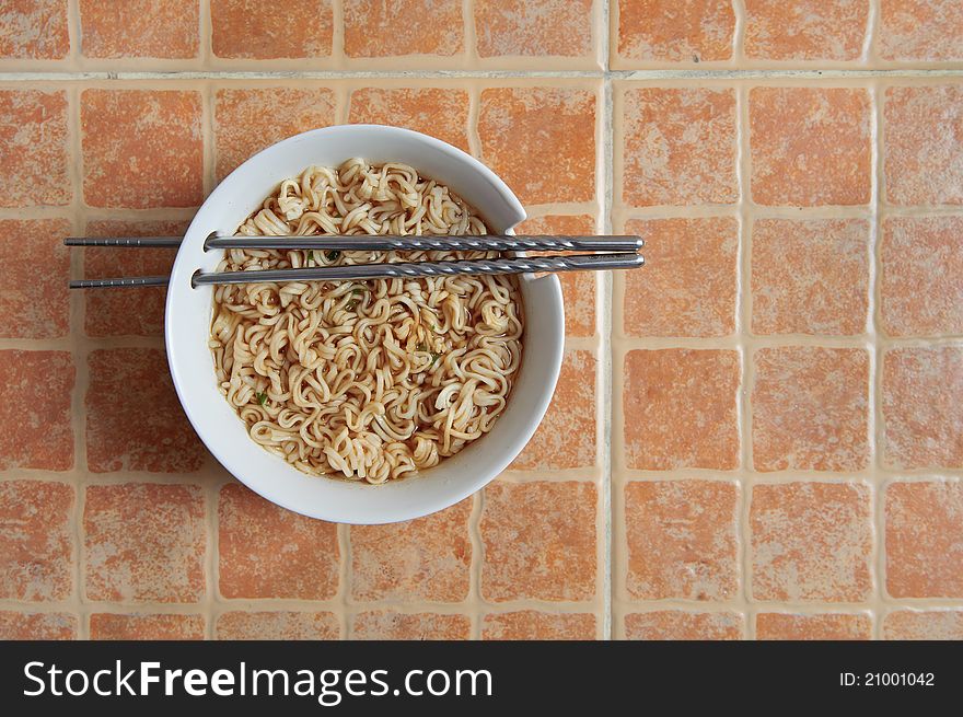 Bowl of Chinese soup on orange background