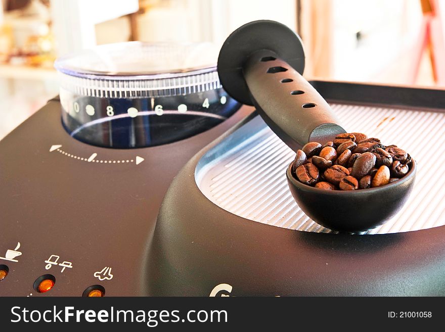 Coffee seed on spoon on coffee machine