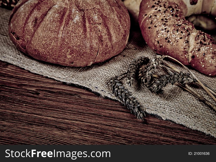 Composition of fresh bread on wooden background