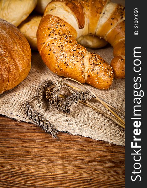 Composition of fresh bread on wooden background