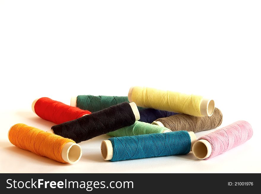 Several variously coloured thread on pile. Several variously coloured thread on pile.