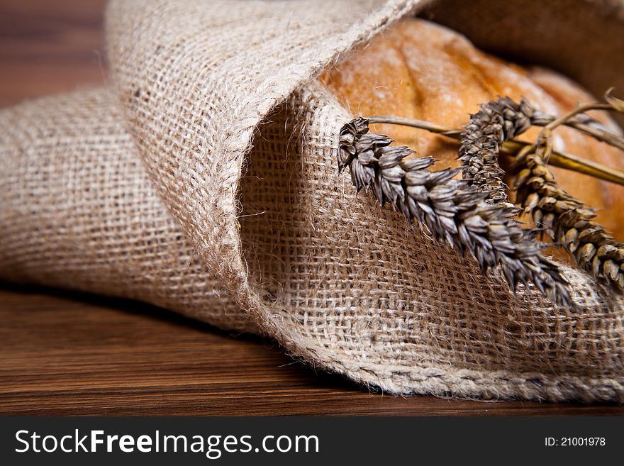 Composition of fresh bread on wooden background