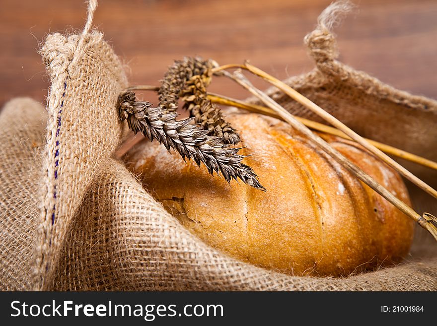 Composition of fresh bread on wooden background