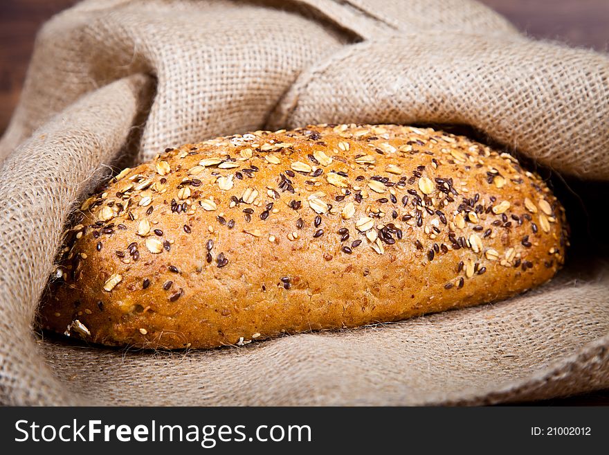 Composition of fresh bread on wooden background