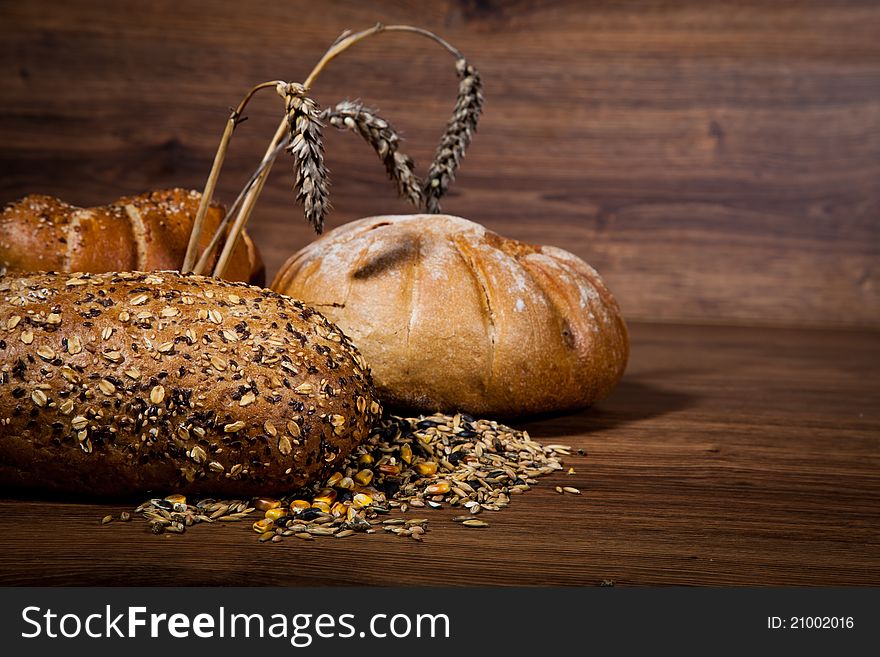 Composition of fresh bread on wooden background