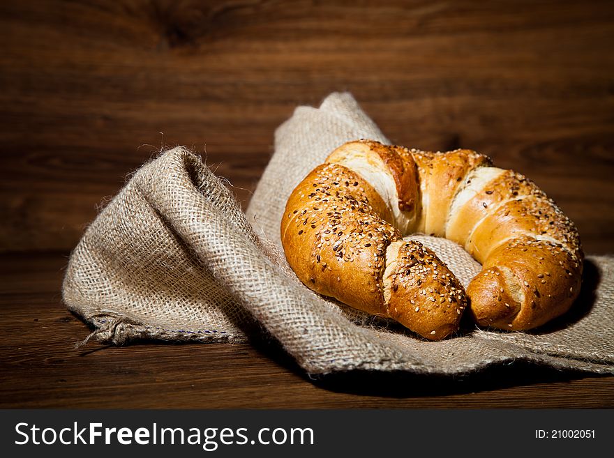 Composition of fresh bread on wooden background