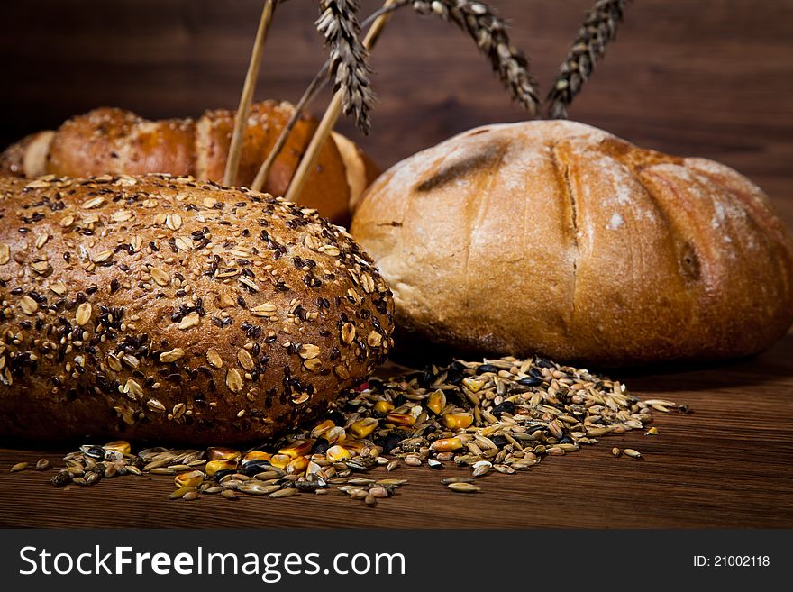 Composition of fresh bread on wooden background