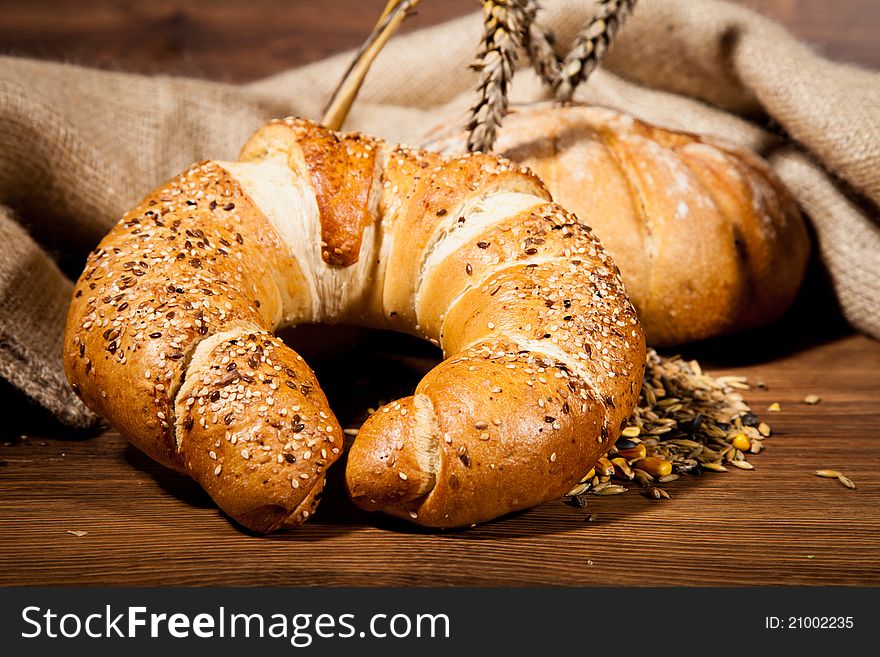 Composition of fresh bread on wooden background