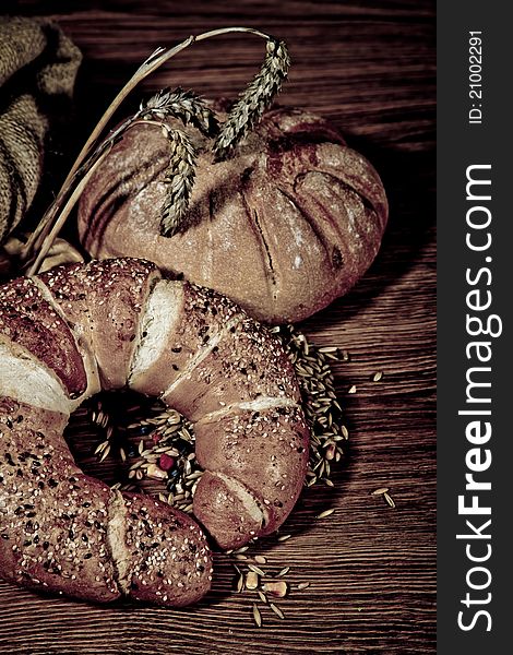 Composition of fresh bread on wooden background