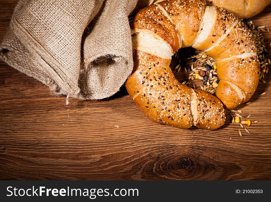 Composition of fresh bread on wooden background