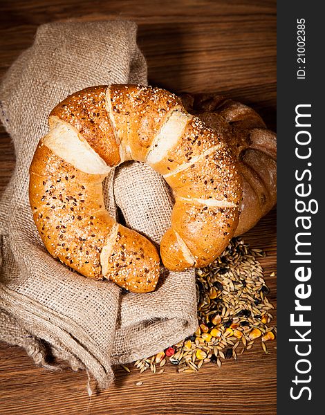 Composition of fresh bread on wooden background