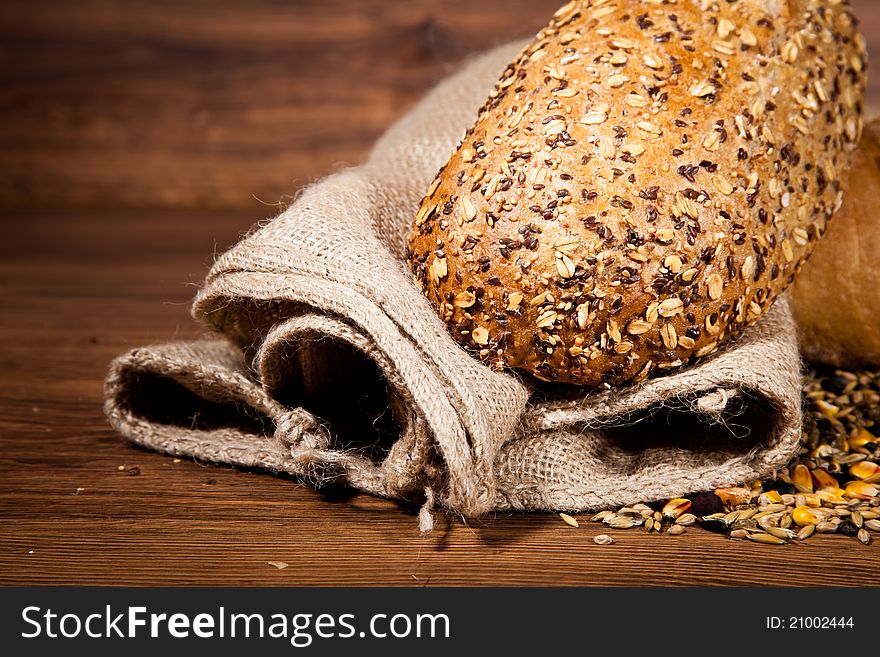 Composition of fresh bread on wooden background