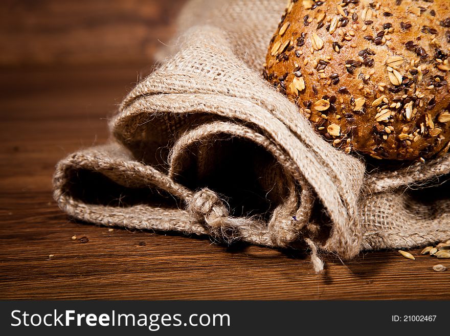 Composition of fresh bread on wooden background